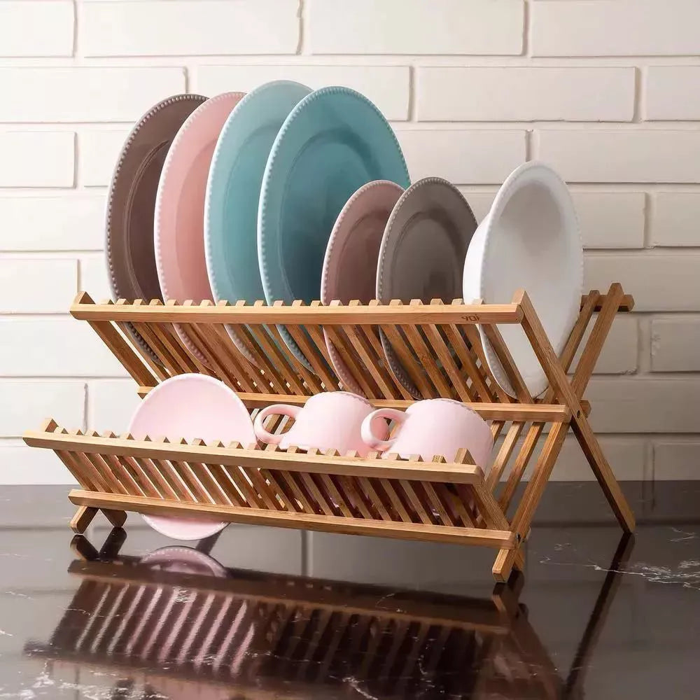 Escorredor de louças de bambu com pratos e bowls coloridos em rosa, azul e cinza organizados nos dois andares.